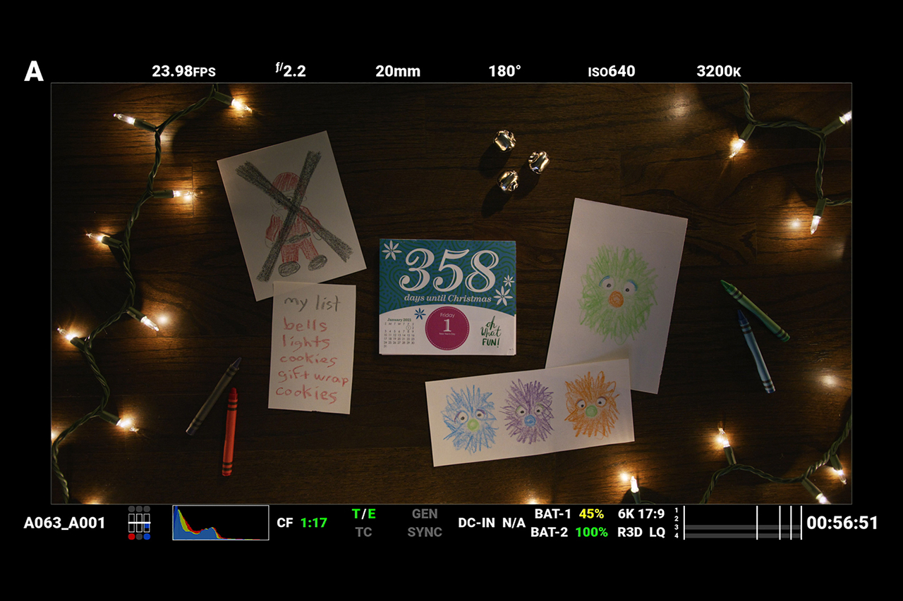 Red Digital Cinema camera monitor screenshot behind the scenes of Christmas film with days till Christmas calendar and lights.