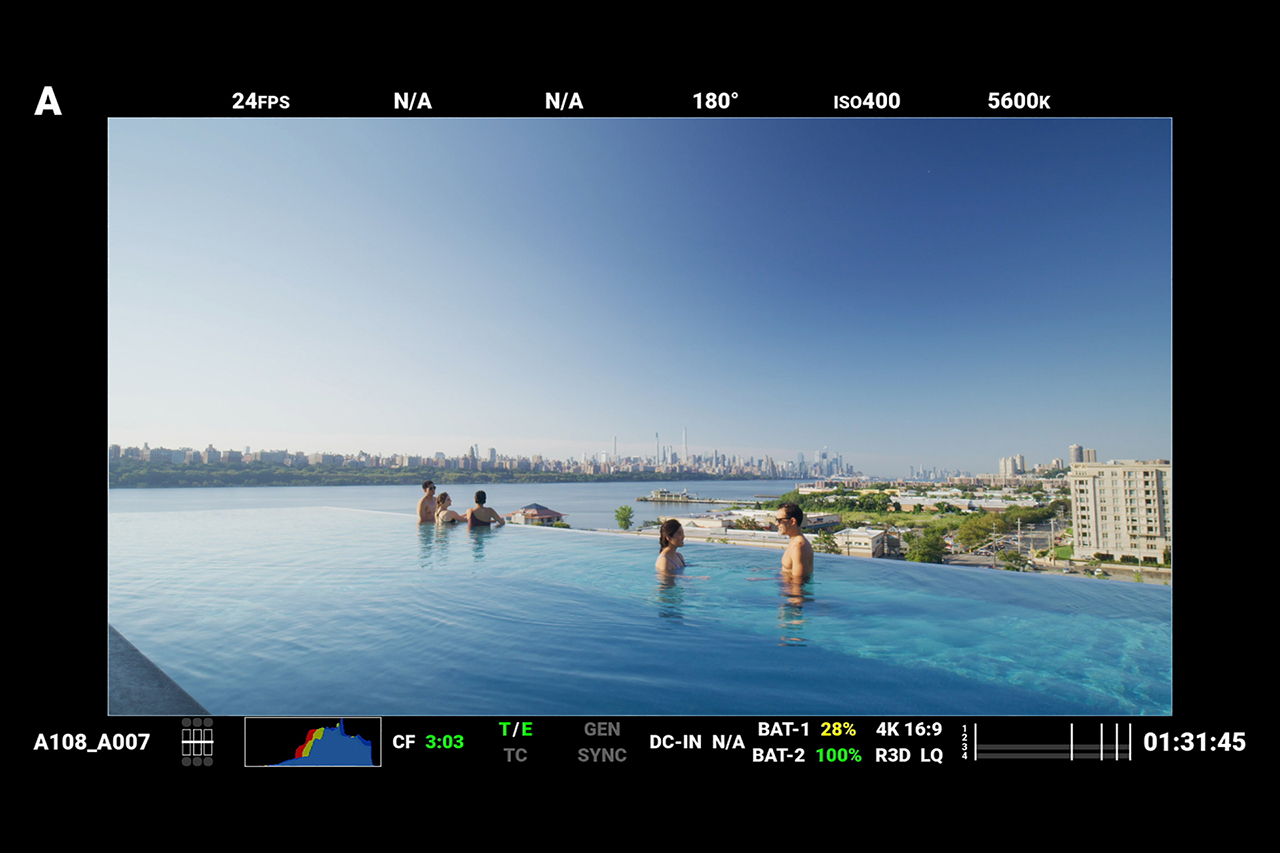 Red Digital Cinema camera monitor screenshot behind the scenes at SoJo Spa Club infinity pool.